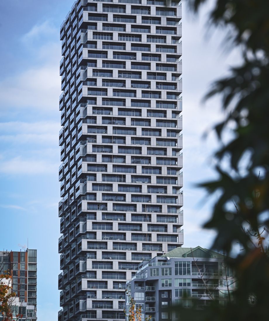 A modern high-rise residential building, run end to end with Indigo
